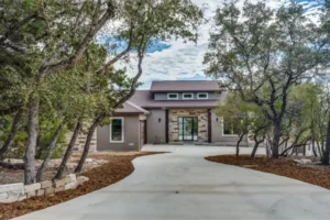 A beautiful driveway leading to a house surrounded by trees.