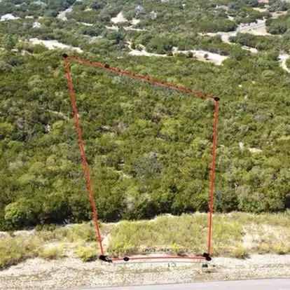 Aerial view showing a property outline in a natural landscape.