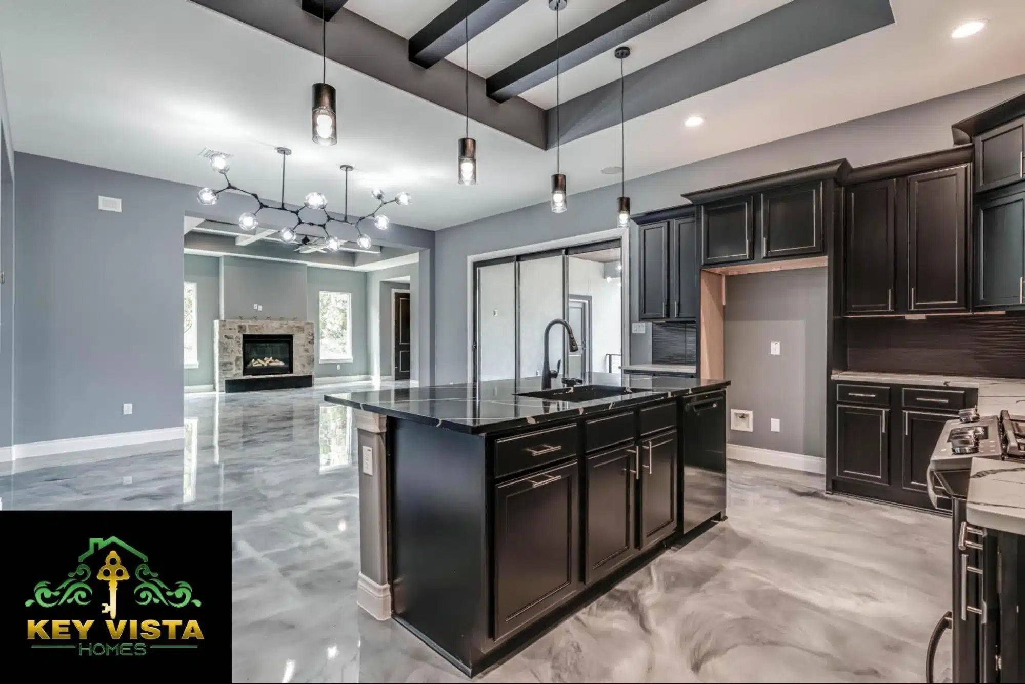 A modern kitchen with sleek black cabinets, an island, and stylish lighting fixtures.