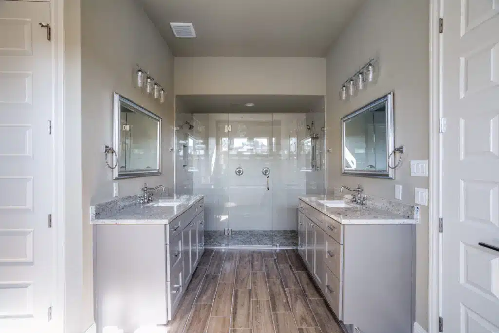 A spacious, modern bathroom with dual vanities.