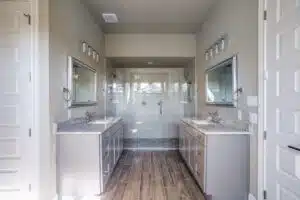 A spacious, modern bathroom with dual vanities.